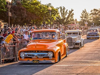 Classic cars driving down victorian square
